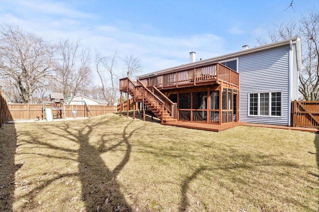 rear view of property with a yard, a wooden deck, a playground, and a fenced backyard