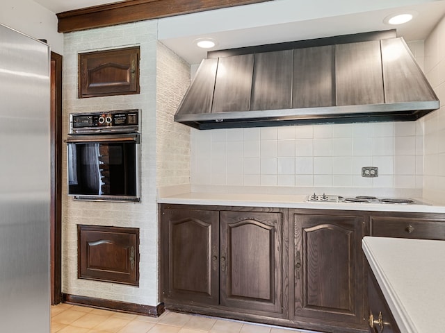 41 Mockingbird Ln, Oak Brook, IL 60523 - kitchen with oven, stainless steel fridge, light countertops, premium range hood, and white electric cooktop