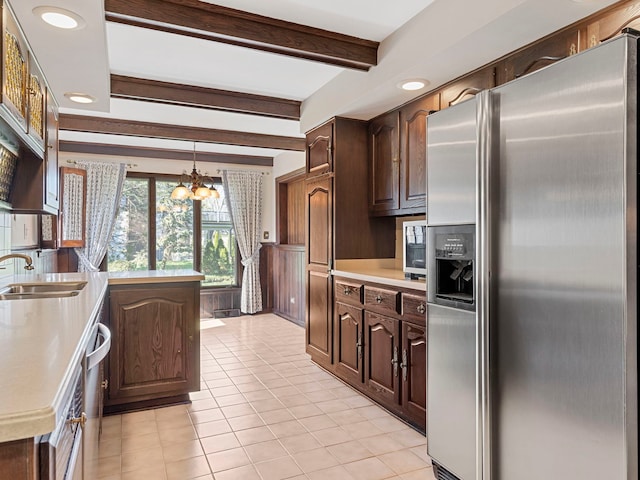 41 Mockingbird Ln, Oak Brook, IL 60523 - kitchen featuring stainless steel fridge, a chandelier, light countertops, light tile patterned flooring, and beamed ceiling