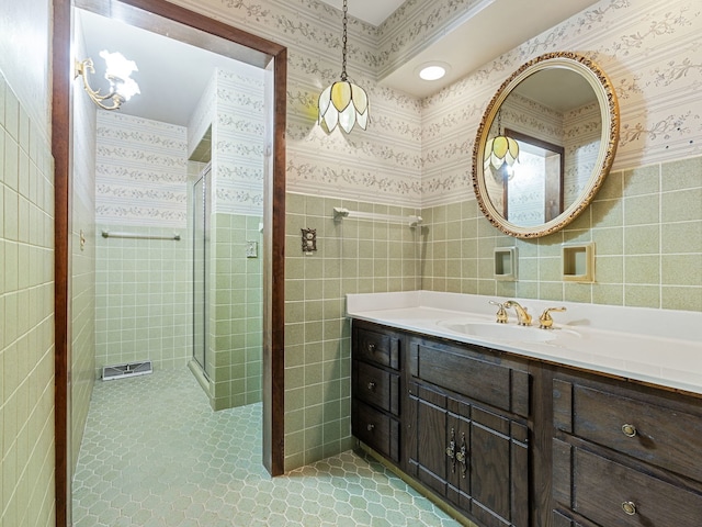 41 Mockingbird Ln, Oak Brook, IL 60523 - bathroom with a stall shower, vanity, tile patterned floors, and tile walls