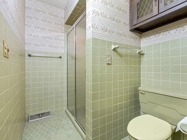 41 Mockingbird Ln, Oak Brook, IL 60523 - full bath with wallpapered walls, a shower stall, tile walls, toilet, and a wainscoted wall