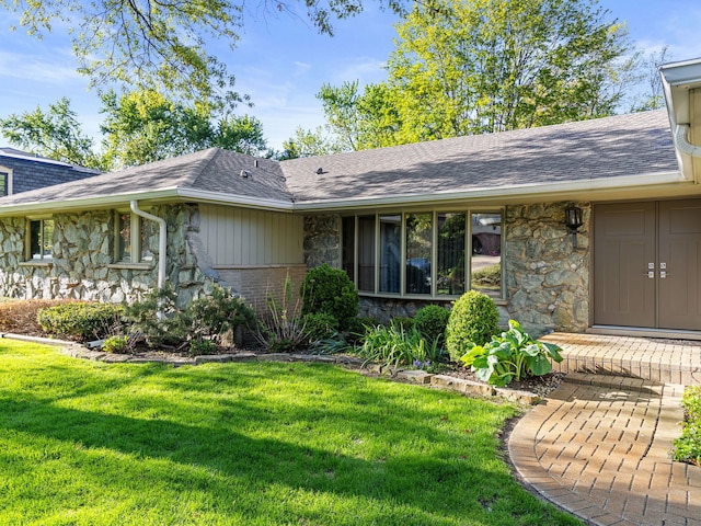 41 Mockingbird Ln, Oak Brook, IL 60523 - view of front of house with stone siding, a shingled roof, and a front yard