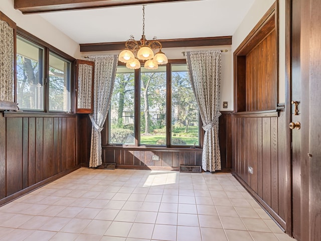 41 Mockingbird Ln, Oak Brook, IL 60523 - unfurnished dining area featuring a chandelier, plenty of natural light, wood walls, wainscoting, and light tile patterned flooring