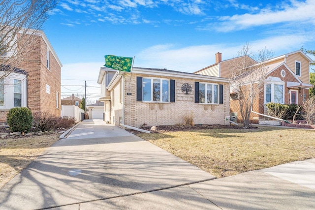 view of front of property with a front lawn, concrete driveway, a garage, brick siding, and a chimney