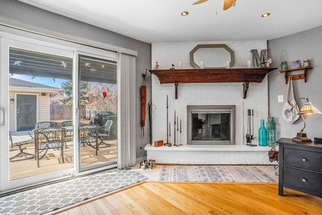 unfurnished living room featuring wood finished floors, recessed lighting, a fireplace, and ceiling fan