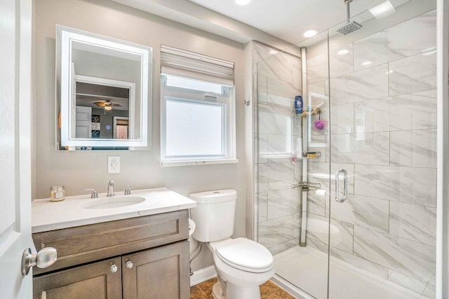 full bathroom with visible vents, toilet, a stall shower, baseboards, and vanity