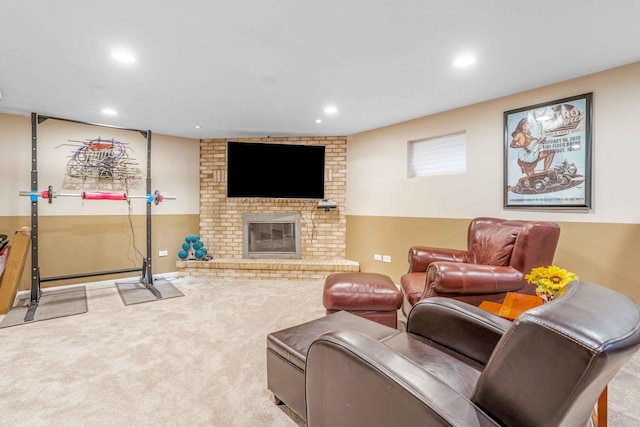 living room featuring recessed lighting, a fireplace, and carpet floors