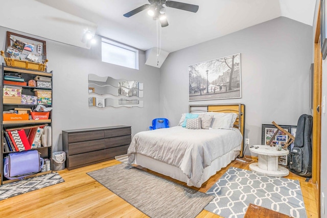 bedroom with lofted ceiling, wood finished floors, and a ceiling fan