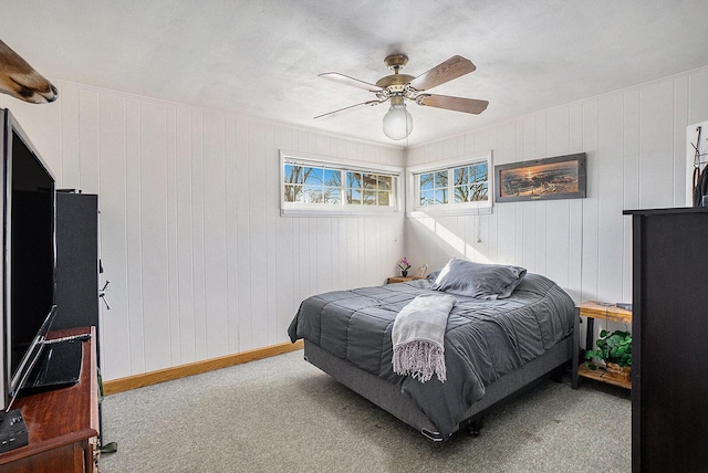 carpeted bedroom with baseboards and a ceiling fan