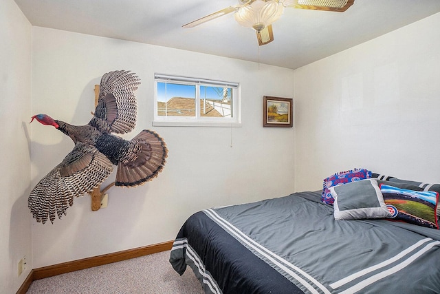 carpeted bedroom featuring baseboards and ceiling fan