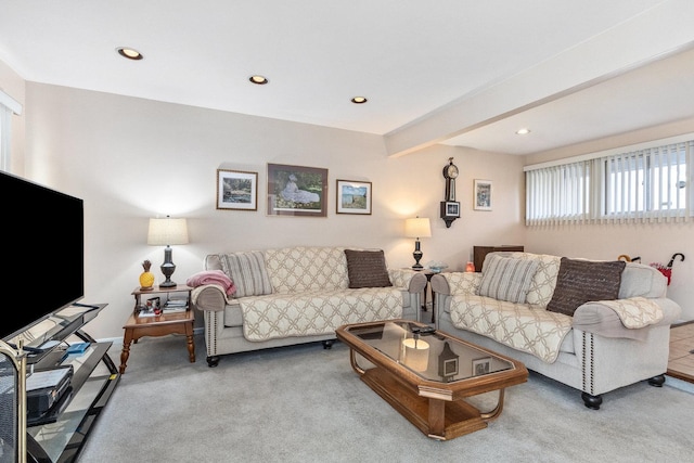 carpeted living room with beamed ceiling and recessed lighting