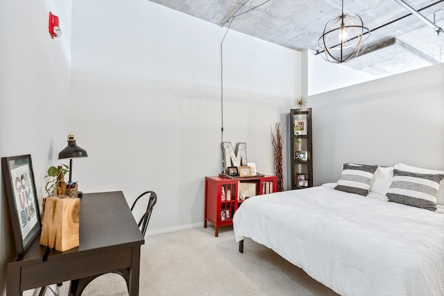 bedroom with light carpet, a notable chandelier, and baseboards