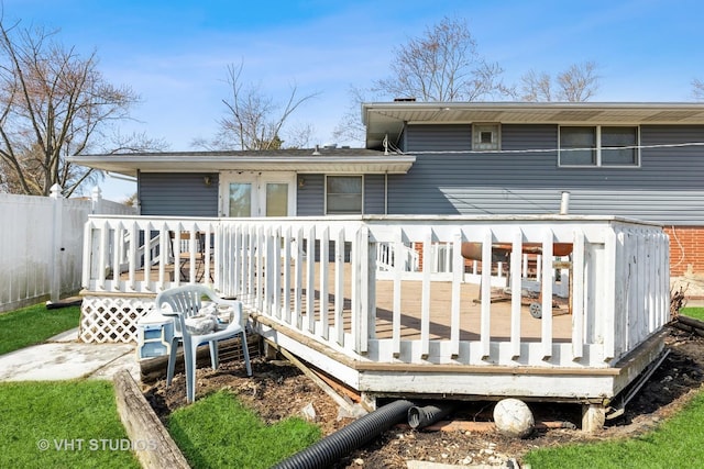 back of house featuring a wooden deck and fence