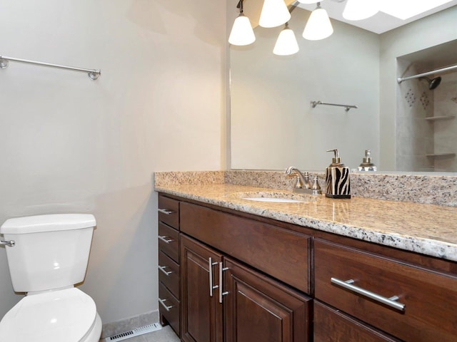 full bathroom with visible vents, toilet, baseboards, walk in shower, and vanity