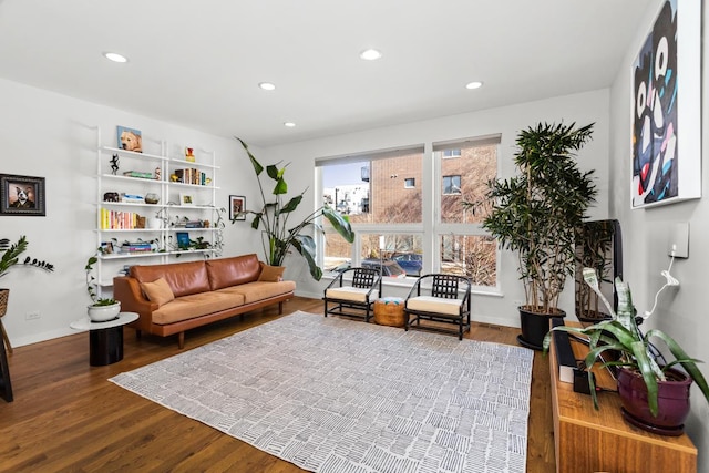 living area featuring recessed lighting, baseboards, and wood finished floors