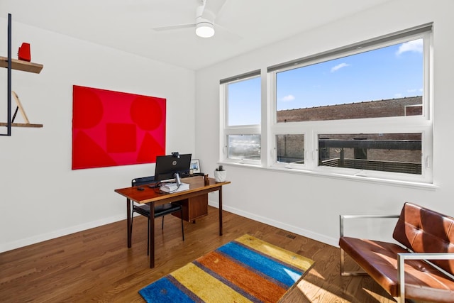 home office with baseboards, wood finished floors, and a ceiling fan