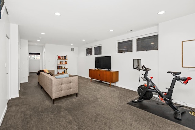 carpeted living area featuring recessed lighting and baseboards