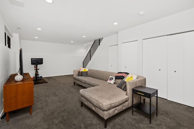 carpeted living room with stairway and recessed lighting