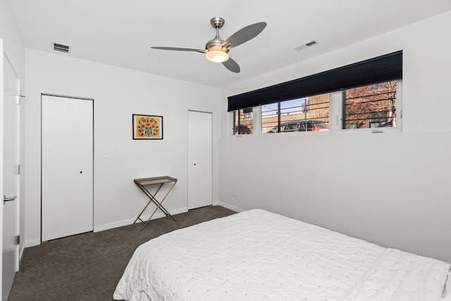 bedroom featuring a ceiling fan, baseboards, visible vents, and dark colored carpet