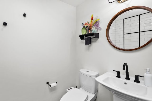 half bath with a sink and toilet