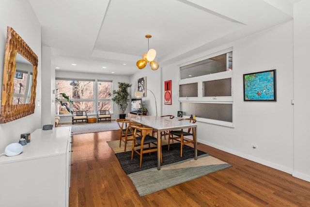 dining space with a chandelier, recessed lighting, baseboards, and wood finished floors