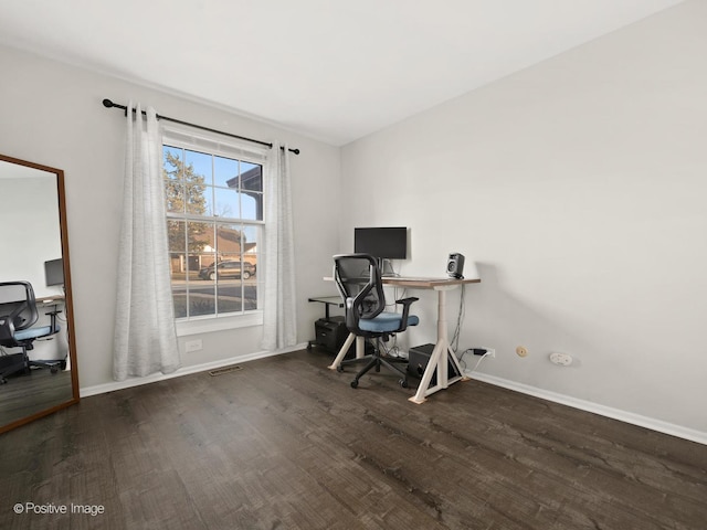 home office featuring visible vents, baseboards, and wood finished floors