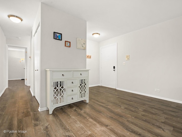 hall with baseboards and dark wood-style flooring