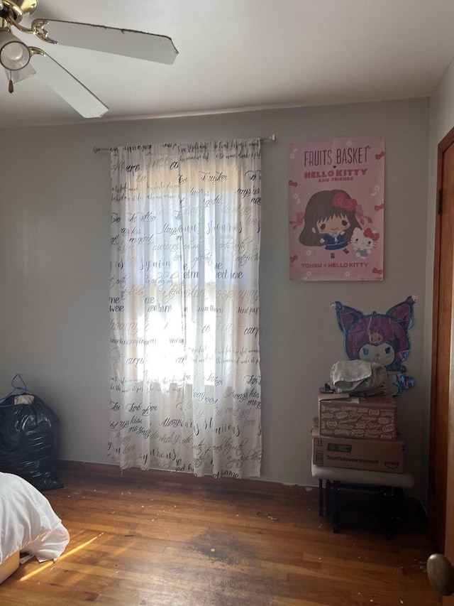 bedroom featuring wood finished floors and a ceiling fan