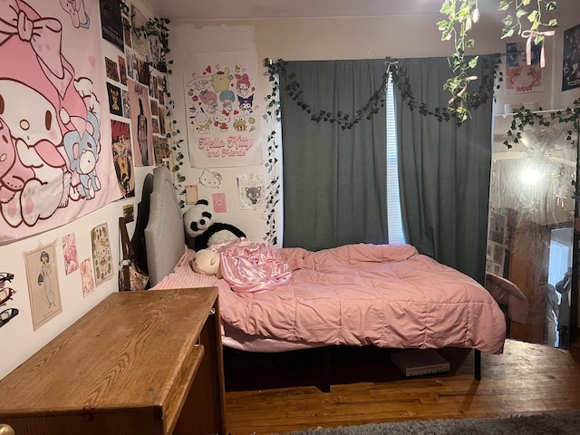 bedroom featuring wood finished floors