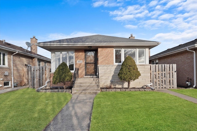 bungalow with brick siding, a chimney, a front lawn, and fence