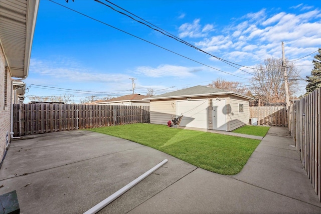 view of yard featuring a garage, a patio, an outdoor structure, and a fenced backyard