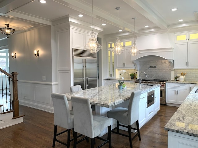 kitchen featuring beamed ceiling, built in refrigerator, dark wood-style floors, white cabinetry, and custom exhaust hood