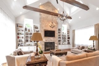 living room featuring recessed lighting, high vaulted ceiling, an inviting chandelier, and a fireplace