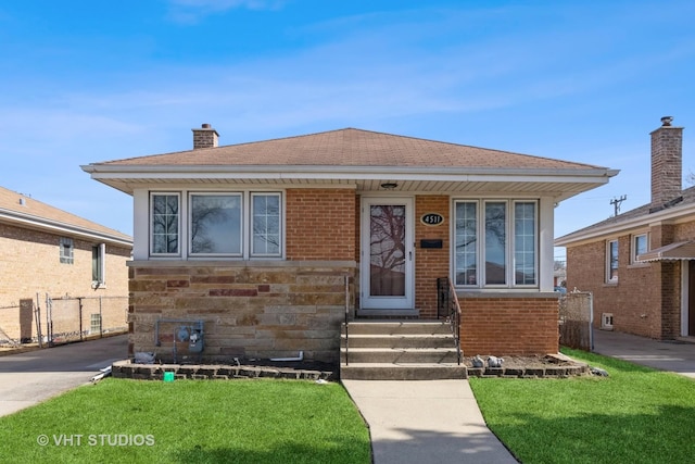 bungalow-style home featuring a front yard, fence, brick siding, and a chimney