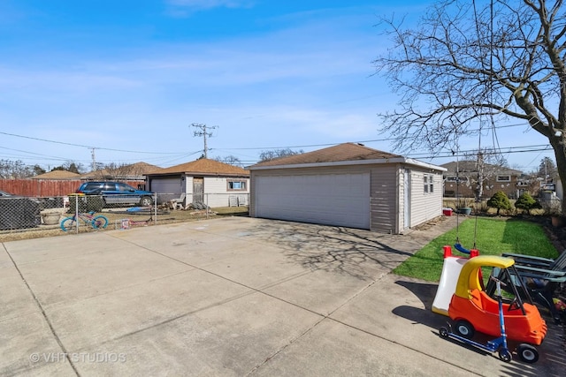 detached garage featuring fence