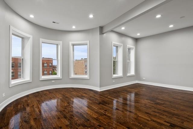 empty room with beamed ceiling, recessed lighting, wood finished floors, and baseboards