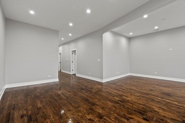 unfurnished room featuring dark wood-type flooring, recessed lighting, and baseboards