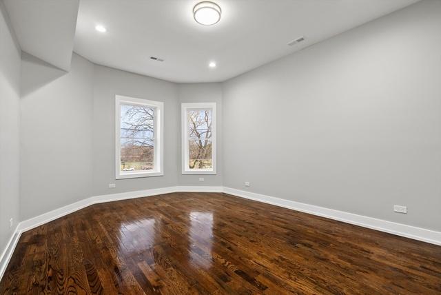 spare room with recessed lighting, visible vents, baseboards, and dark wood-style floors