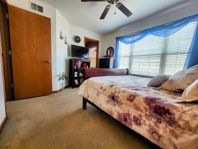 bedroom with visible vents, carpet floors, baseboards, and a ceiling fan