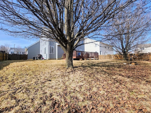 view of yard featuring a deck and fence