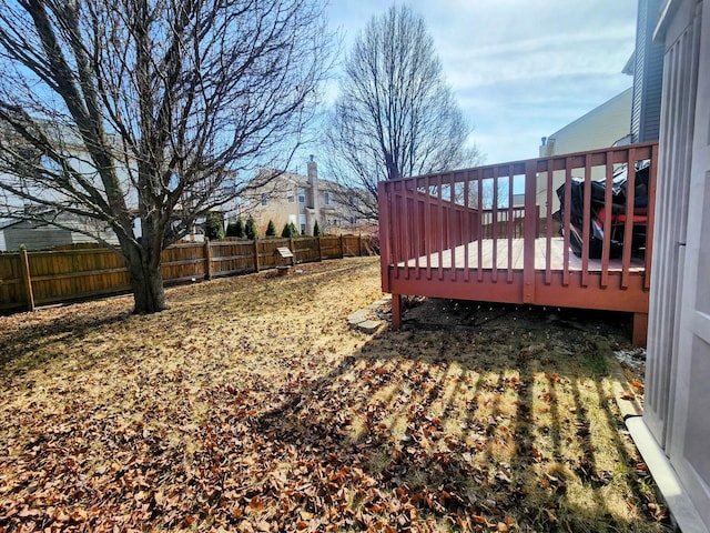 view of yard with a fenced backyard and a wooden deck