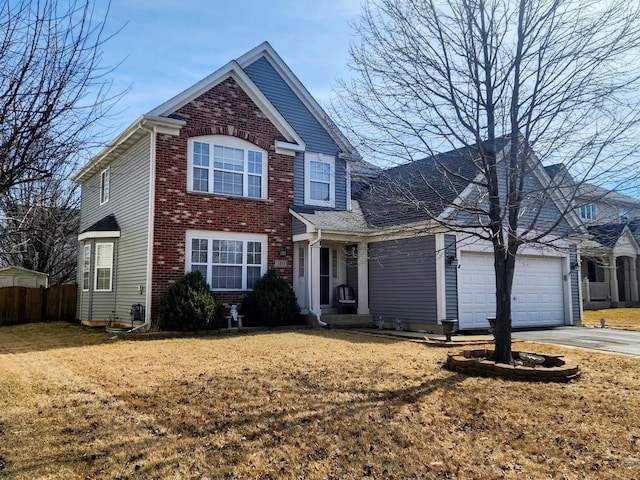 traditional-style house featuring brick siding, a front lawn, fence, concrete driveway, and a garage