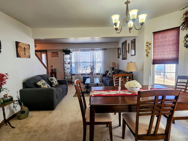 dining area with light carpet and an inviting chandelier