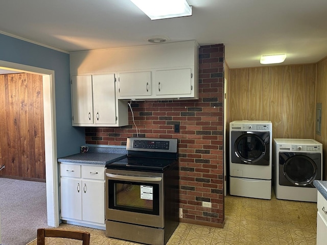 kitchen featuring white cabinetry, dark countertops, stainless steel electric stove, and washing machine and dryer