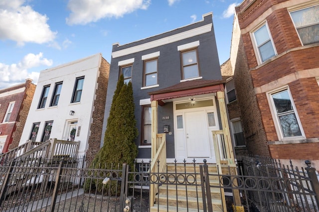 townhome / multi-family property featuring a fenced front yard