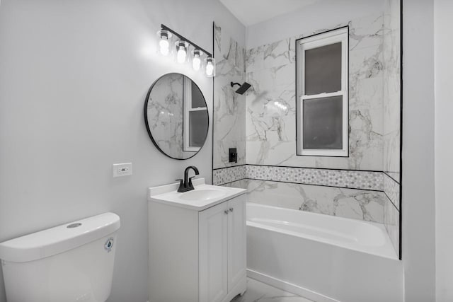 bathroom featuring marble finish floor, tub / shower combination, toilet, and vanity