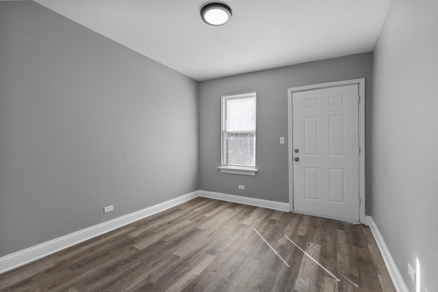 interior space with wood finished floors and baseboards