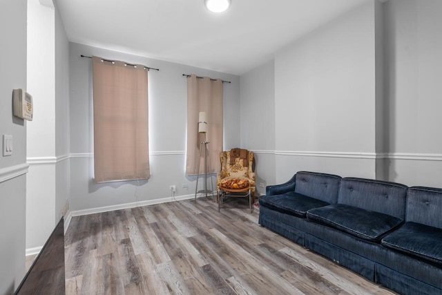 sitting room with wood finished floors and baseboards