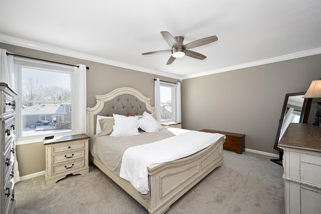 bedroom with light colored carpet, a ceiling fan, baseboards, and ornamental molding