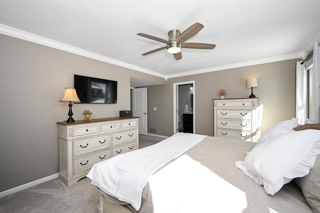 bedroom featuring ensuite bath, crown molding, baseboards, light colored carpet, and ceiling fan